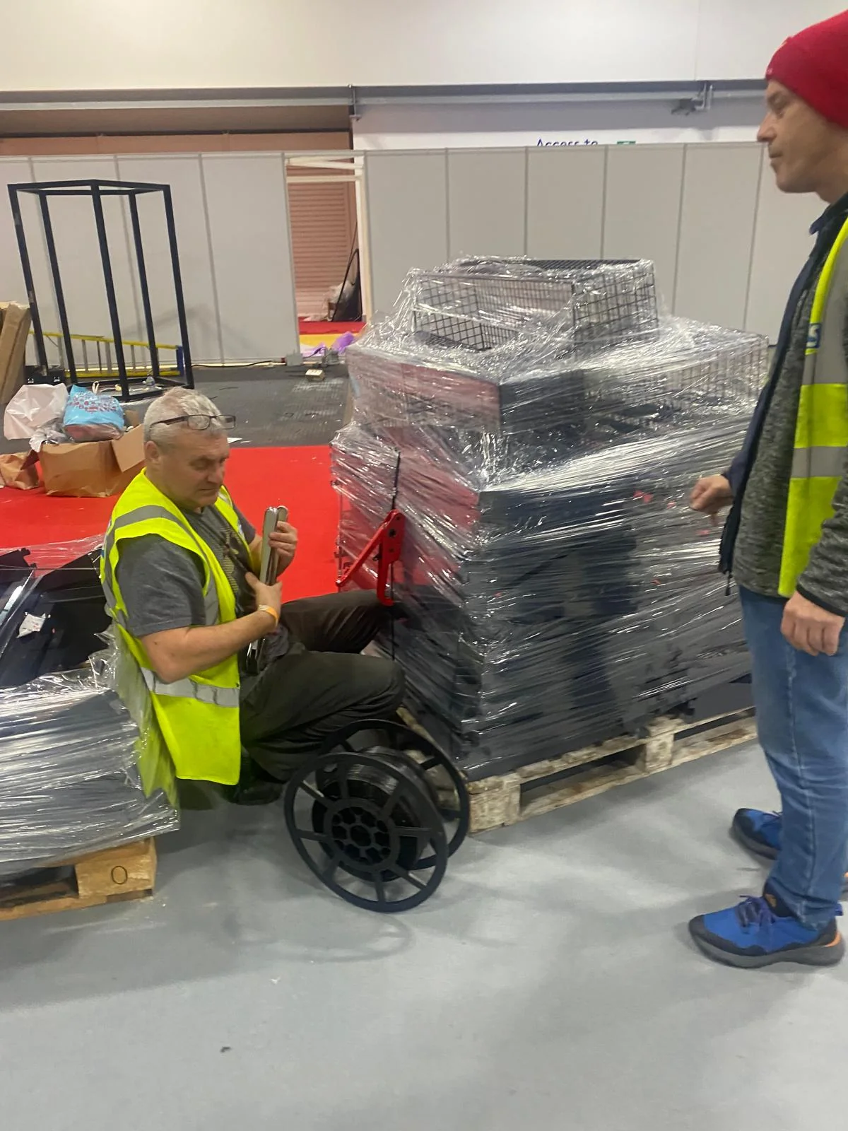 Wrapped retail fixtures staged on pallets before installation