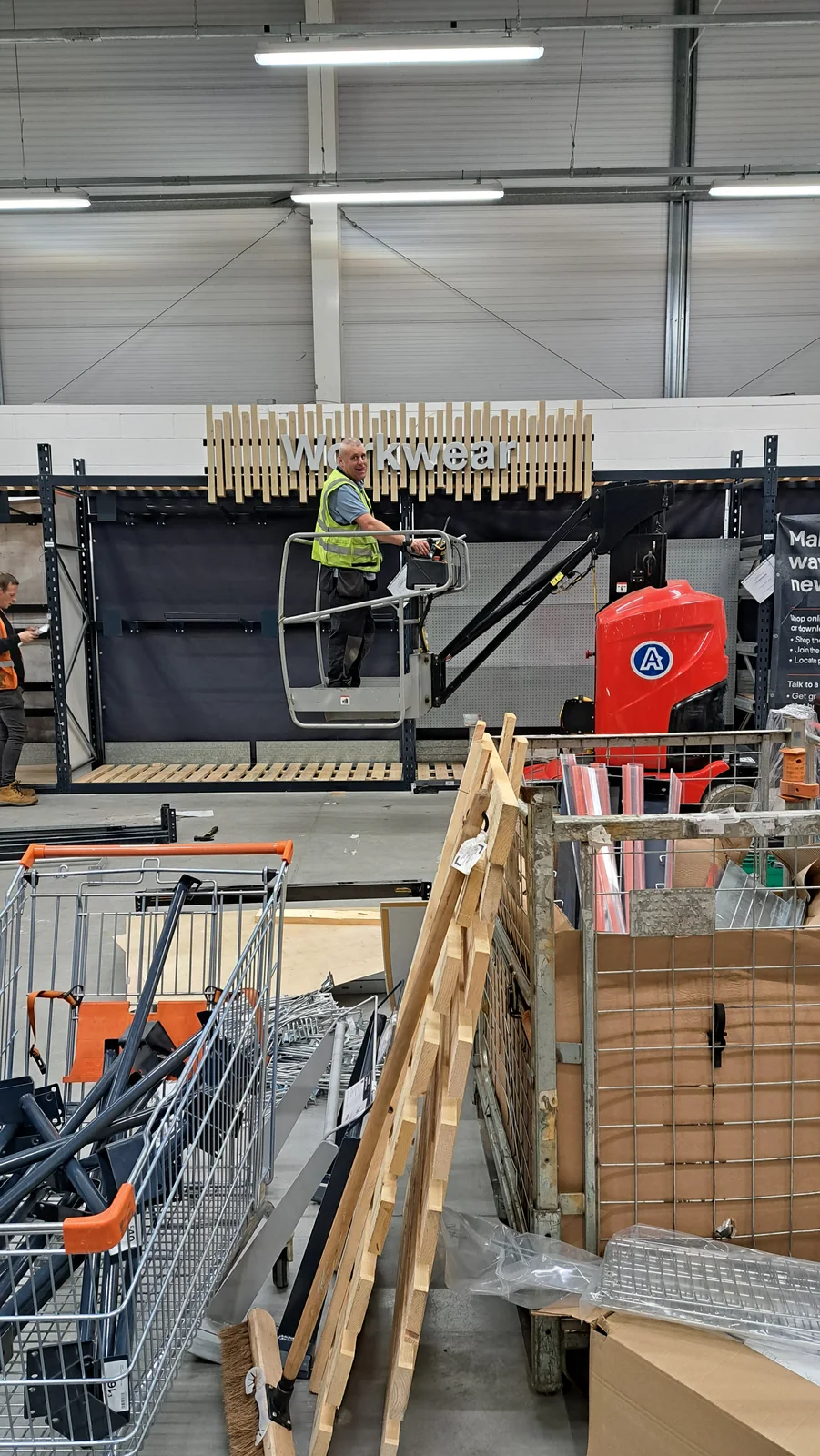 Workwear retail bay being installed using powered access